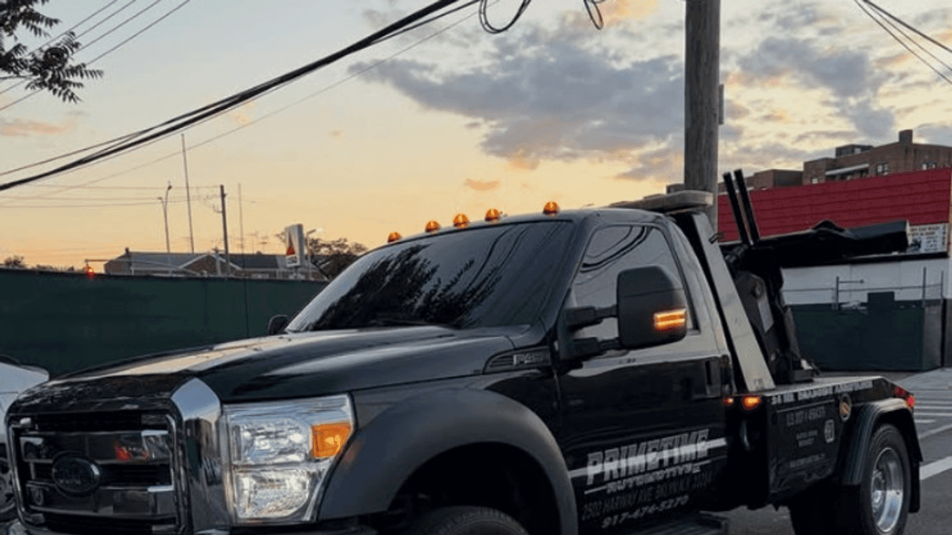 Primetime Automotive Ford wrecker at dusk in Brooklyn